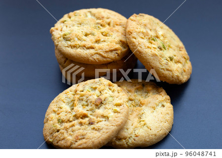 Pistachio and almond cookies on dark background. 96048741