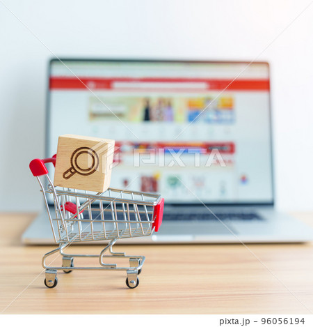 Shopping cart with Magnifying icon block and laptop computer with marketplace website, technology, ecommerce, SEO, Search Engine Optimization, Advertising, keyword and online payment concept 96056194