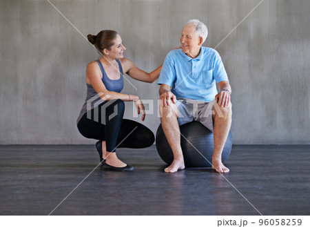 Helping my patients recover is my only priority. Shot of a a physical therapist working with a senior man. Helping my patients recover is my only priority. Shot of a a physical therapist working with a senior man. 96058259