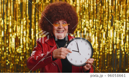 Stylish senior woman showing time on clock watch, ok, thumb up, approve, pointing finger at camera 96058661