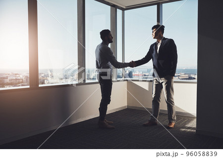 Well rise to greater heights together. Shot of two businessmen shaking hands in an office. Well rise to greater heights together. Shot of two businessmen shaking hands in an office. 96058839