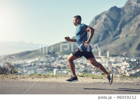 Running is one of the best ways to stay fit. Shot of a young handsome man running outdoors. Running is one of the best ways to stay fit. Shot of a young handsome man running outdoors. 96059212