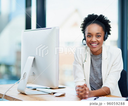 What can I do for you. Cropped portrait of a young businesswoman wearing a headset while sitting in her office. 96059288