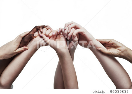 Embracing unity through diversity. Shot of a group of hands holding on to each other against a white background. 96059355