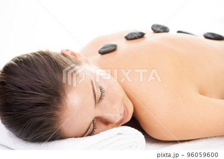 Relaxation at last. Cropped shot of a young woman getting a beauty treatment isolated on white. Relaxation at last. Cropped shot of a young woman getting a beauty treatment isolated on white. 96059600