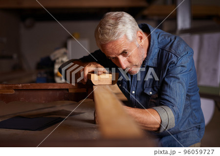 Woodwork pro. Shot of a mature male carpenter working on a project in his workshop. 96059727
