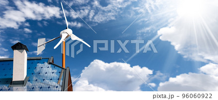 Solar Panels and Small Wind Turbine on the top of a Roof of a House Solar Panels and Small Wind Turbine on the top of a Roof of a House 96060922