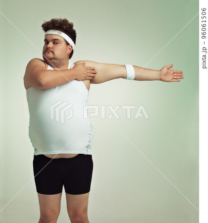 Stretching is important. Overweight man doing arm stretches. Stretching is important. Overweight man doing arm stretches. 96061506