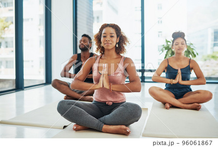 One moves into an asana till the limit is felt. Shot of a group of people doing yoga. One moves into an asana till the limit is felt. Shot of a group of people doing yoga. 96061867