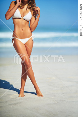 Her body was made for the beach. Cropped shot of a gorgeous woman in a bikini at the beach. Her body was made for the beach. Cropped shot of a gorgeous woman in a bikini at the beach. 96061869