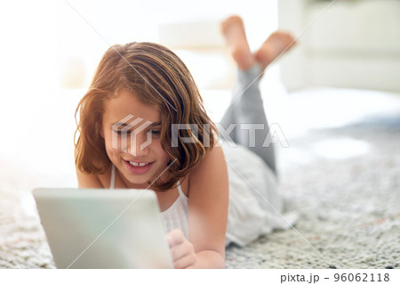 Cute and carefree. Shot of a cute little girl at home. 96062118