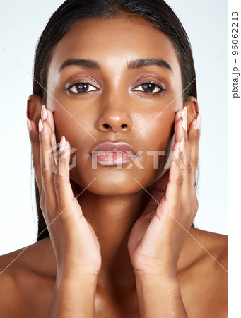 Nothing highlights your beauty like healthy skin. Studio shot of a beautiful young woman posing against a light background. Nothing highlights your beauty like healthy skin. Studio shot of a beautiful young woman posing against a light background. 96062213