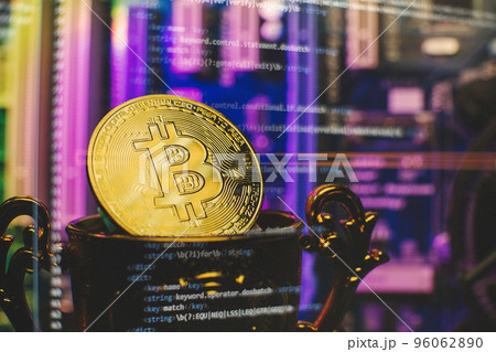 Cryptocurrency concept , Golden bitcoin on winners cup background mainboard , The future of money. Computational equipment. 96062890