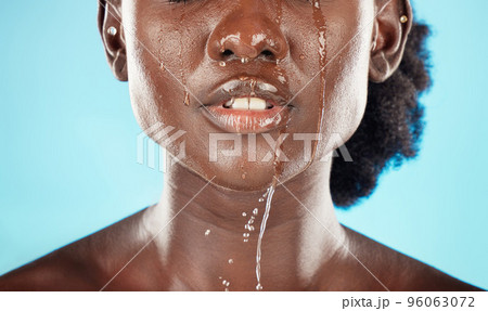 Water, mouth and face of a black woman with drops on her lips for hygiene, grooming and cleansing. Beauty, skincare and hydrating facial for an african american female with oral cleaning treatment 96063072
