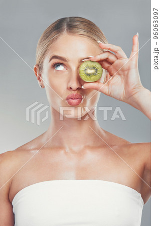 Thinking, beauty and woman with kiwi face for organic skincare, health and cosmetic product. Thoughtful skin model girl for fruit cosmetic treatment marketing with gray gradient background. Thinking, beauty and woman with kiwi face for organic skincare, health and cosmetic product. Thoughtful skin model girl for fruit cosmetic treatment marketing with gray gradient background. 96063097