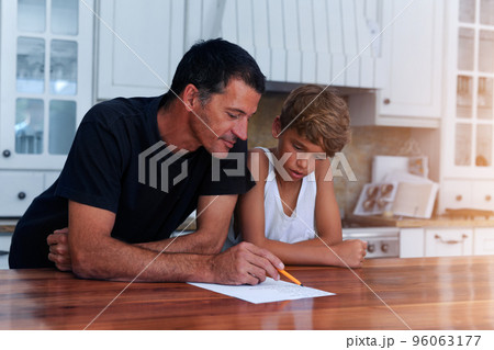 Getting children involved in household chores has benefits for everyone. Cropped shot of a father going over a list of chores with his son at home. 96063177