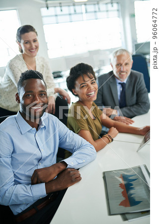 Its been a great day at the office. Portrait of a group of coworkers sitting together in an office. Its been a great day at the office. Portrait of a group of coworkers sitting together in an office. 96064772