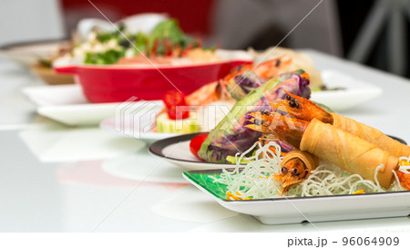 Fried Shrimps wrapped and crispy fried noodles with various food as background 96064909