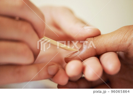 Working magic on her nails. Cropped shot of a woman getting a manicure. 96065864