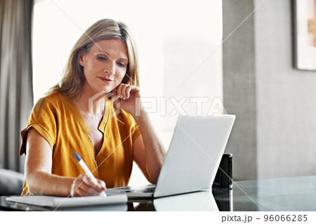 She likes to stay organzied. Shot of a mature woman using a laptop at home. 96066285