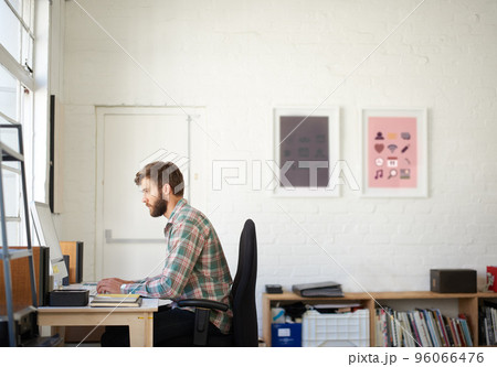 Confident and creative. Portrait of a handsome businessman working in his office. Confident and creative. Portrait of a handsome businessman working in his office. 96066476
