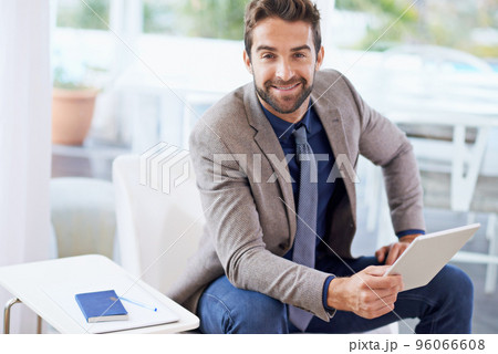 Stop dreaming start doing. Shot of a businessman using his digital tablet. Stop dreaming start doing. Shot of a businessman using his digital tablet. 96066608