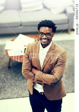 I made the perfect career choice. Portrait of a confident young businessman standing in an office. 96066719