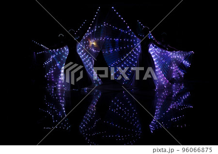 Laser show performance, dancers in suits with LED lamp, very beautiful night club party. 96066875