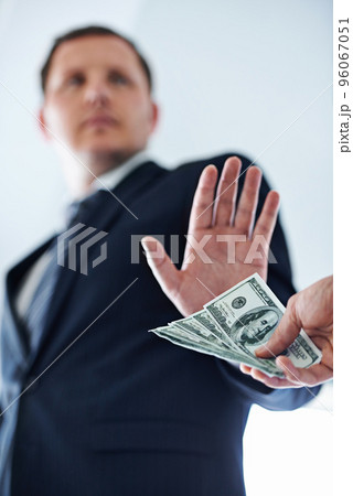 No deal. Low-angle view of a businessman refusing a bribe. No deal. Low-angle view of a businessman refusing a bribe. 96067051