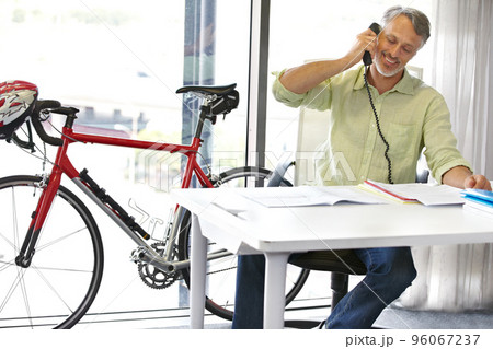 On an important business call. Cropped shot of a mature businessman talking on his phone in the office. 96067237