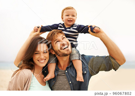 Find what brings you joy and go there. Cropped shot of a young couple and their son at the beach. 96067802