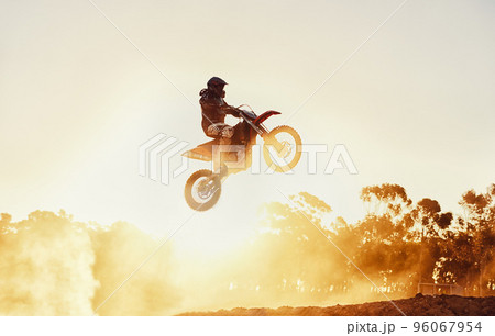 Hes way out in front. A shot of a motocross rider in midair during a race. Hes way out in front. A shot of a motocross rider in midair during a race. 96067954