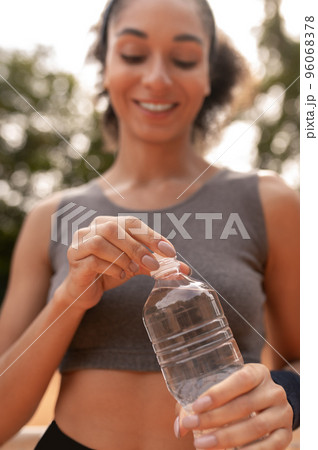 Cute young girl feeling thirsty after workout Cute young girl feeling thirsty after workout 96068378