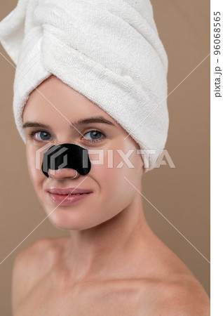 Close up of a girl with a cleansing nose stripe 96068565