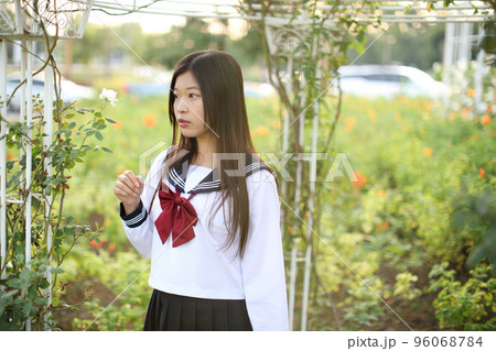 school girl costume at park outdoor with flowers garden background 96068784