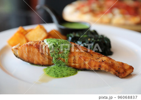 Salmon steak with pesto sauce Salmon steak with pesto sauce 96068837