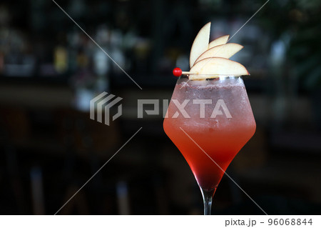 Pink Cocktail glass with ice at a bar counter 96068844