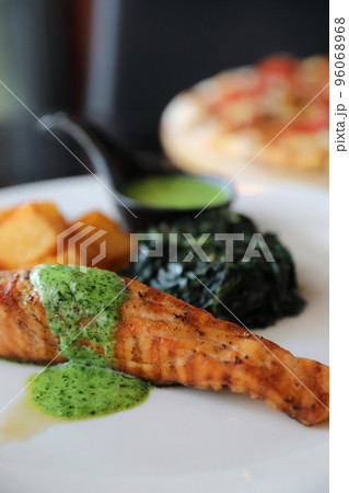 Salmon steak with pesto sauce 96068968