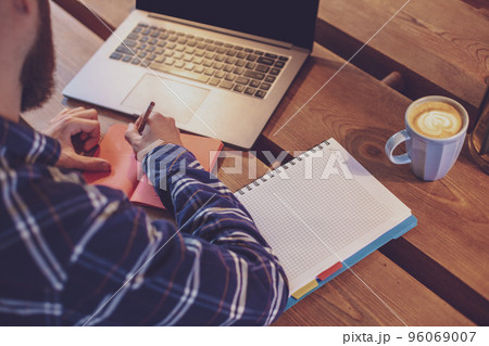 Cropped image of casual business man or freelancer planning his 96069007