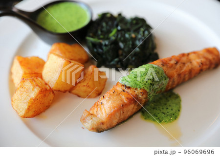 Salmon steak with pesto sauce 96069696