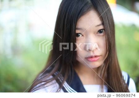 close face of school girl costume at park outdoor with flowers garden background 96069874