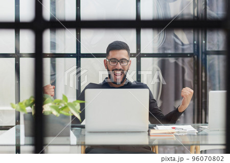 Business man sitting at his desk in the office 96070802