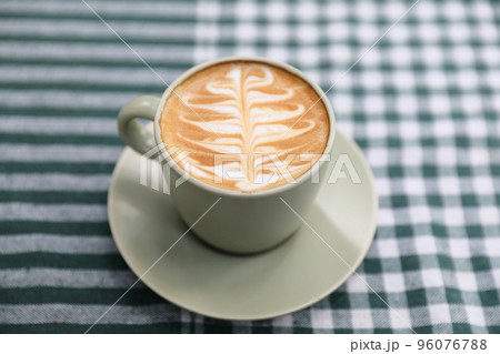hot cappuccino with latte art on wood background 96076788