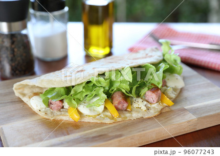 Italian cuisine , Piadina with sausage and cheese 96077243