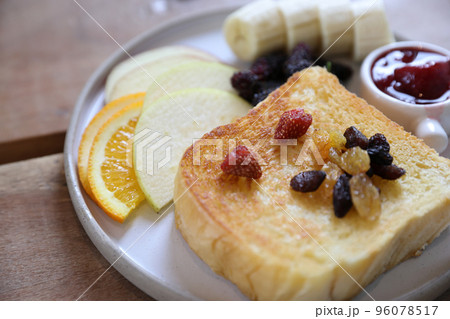 Toast breakfast with dried berry and jam on wood background Toast breakfast with dried berry and jam on wood background 96078517