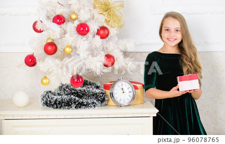Favorite day of the year. Kid girl near christmas tree hold gift box. Time to open christmas gifts. Merry christmas concept. Dreams come true. Best for our kids. Child celebrate christmas at home 96078765