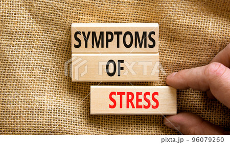 Symptoms of stress symbol. Concept words Symptoms of stress on wooden blocks. Beautiful canvas table canvas background. Doctor hand. Psychological business and Symptoms of stress concept. Copy space. 96079260