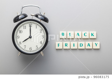 Black friday text and alarm clock on gray background. Top view. Black friday text and alarm clock on gray background. Top view. 96083175