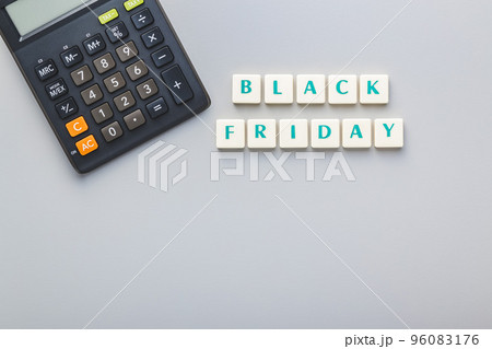 Black friday text and calculator on gray background. Top view. Black friday text and calculator on gray background. Top view. 96083176