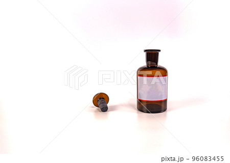 Brown medical jar with a glass stopper on a white background with a label 96083455